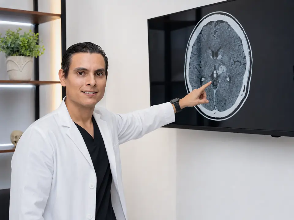 Dr. Mallyolo Pelayo revisando un estudio cerebral anonimizado en consulta en Puebla